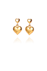 A pair of gold duo heart shaped earrings with a small heart at the top and a big heart at the bottom on each side without background 