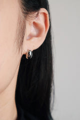 Black hair girl wearing classic and simple oval studs