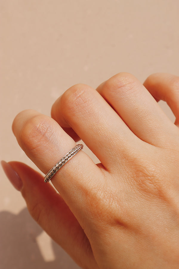 Woman wearing silver rop ring on her point finger