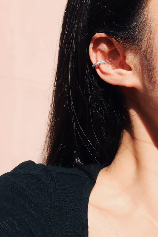 Black hair woman showing her half face that wearing sterling silver shiny ear clip 