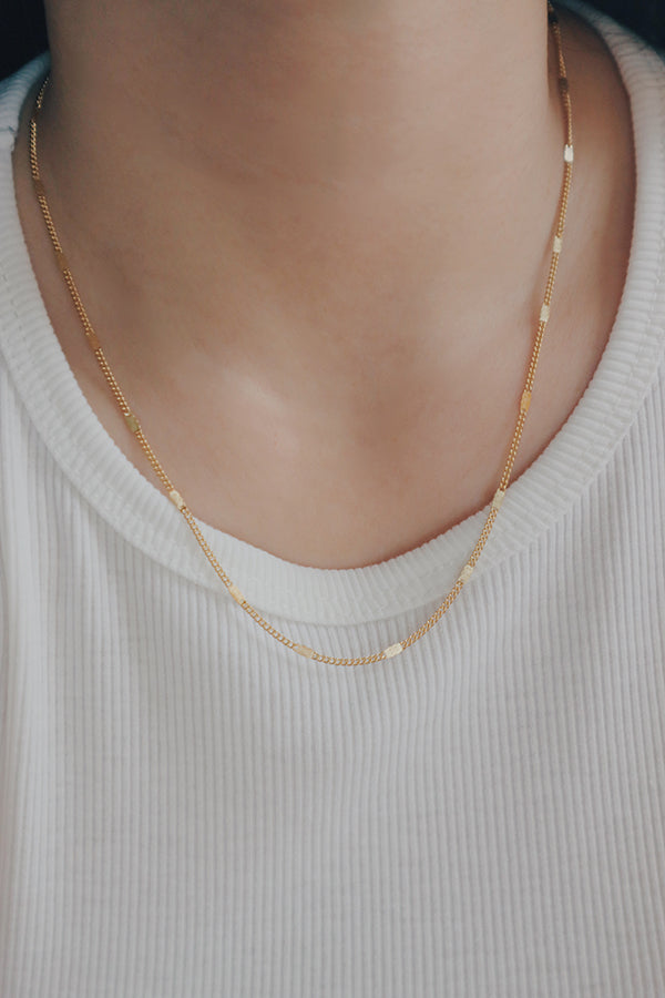 A luxurious 18K gold-plated layering necklace from SH & Co., ideal for adding depth to any fashion ensemble.