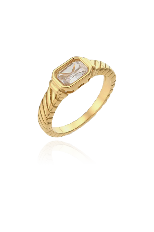 A sophisticated gold-plated ring featuring a rectangular-cut white cubic zirconia gemstone. The band is adorned with a textured design that resembles a rope pattern, adding a touch of elegance and refinement to the piece. The clear, sparkling stone is set securely within a sleek bezel, making it a versatile and timeless accessory for any outfit.