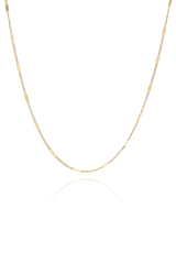 A versatile gold chain necklace from SH & Co., designed for essential layering, featuring lightweight links.