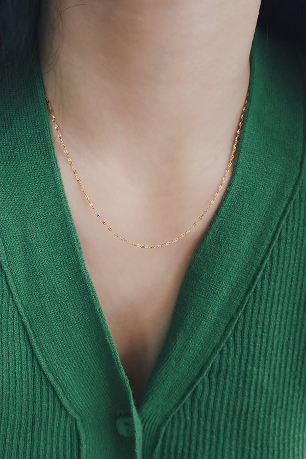 A woman wearing a high-quality gold-plated necklace by SH & Co., highlighting its premium finish and durability.