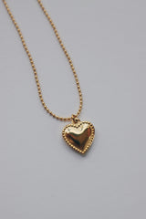 Delicate hypoallergenic heart beads necklace by SH & Co., featuring small gold heart pendants along a thin chain, perfect for sensitive skin.