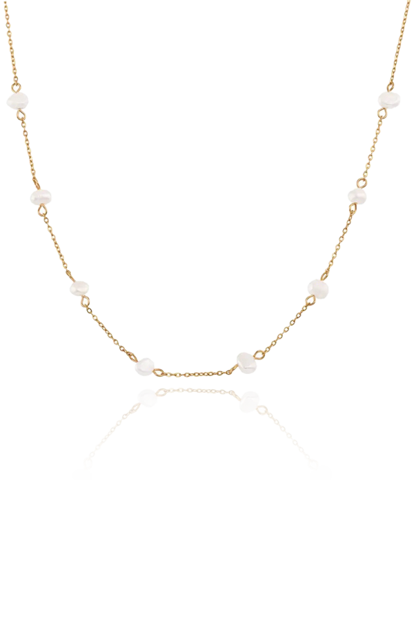 Refined Ivanna necklace with a minimalist design, featuring delicate pearls evenly spaced along a slender gold chain, perfect for elegant layering.