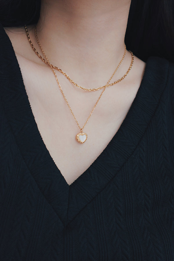 Elegant display of layered gold necklaces from SH & Co., featuring different textures and lengths for a trendy look.