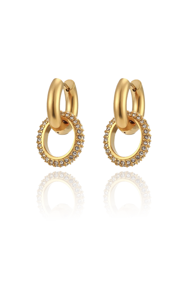 A product image of gold hoop earrings, featuring a dangling circular charm encrusted with cubic zirconia stones. The earrings combine a classic hoop design with a touch of sparkle, making them both elegant and eye-catching.