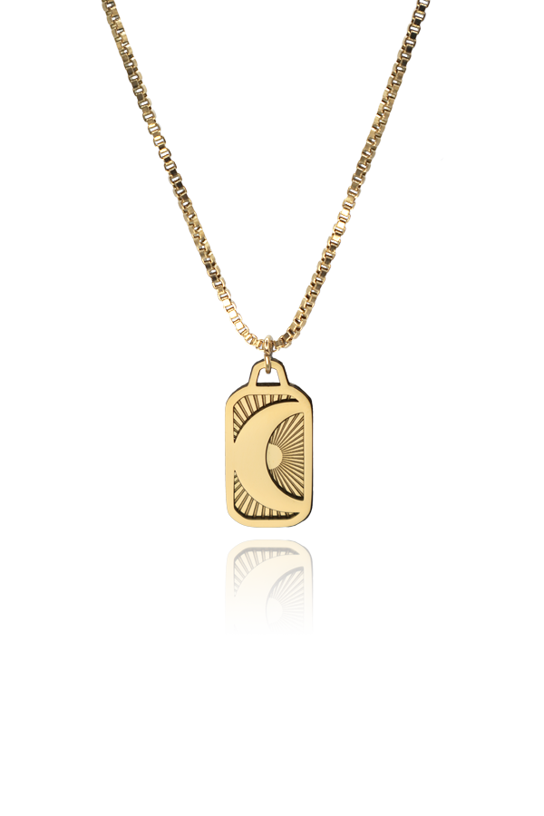 Product image of the Phoebe Luna necklace, featuring a rectangular gold-plated pendant with a crescent moon and sunburst engraving, displayed on a white background.