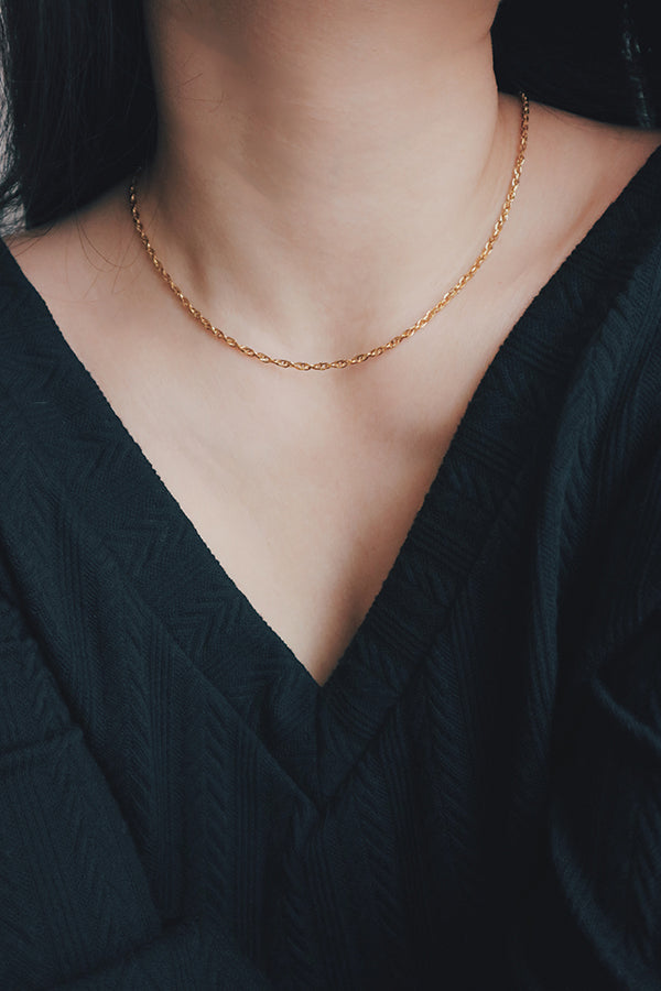 Detail of a tarnish-free gold necklace from SH & Co., highlighting its durable and shiny finish.