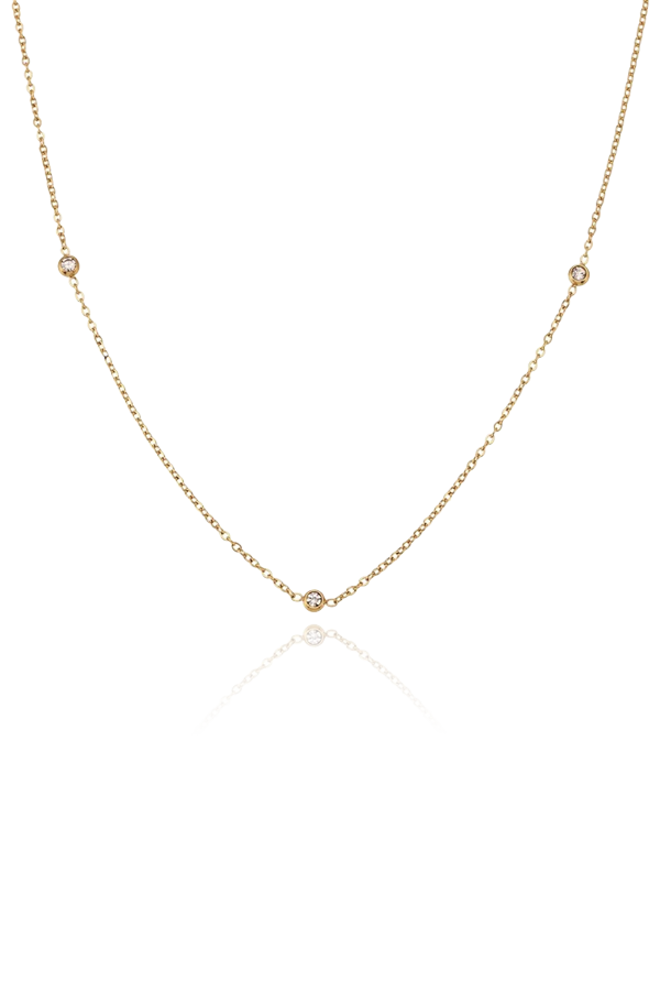 Product image of a stainless steel necklace featuring small, bezel-set cubic zirconia stones along a delicate gold chain, displayed on a white background.